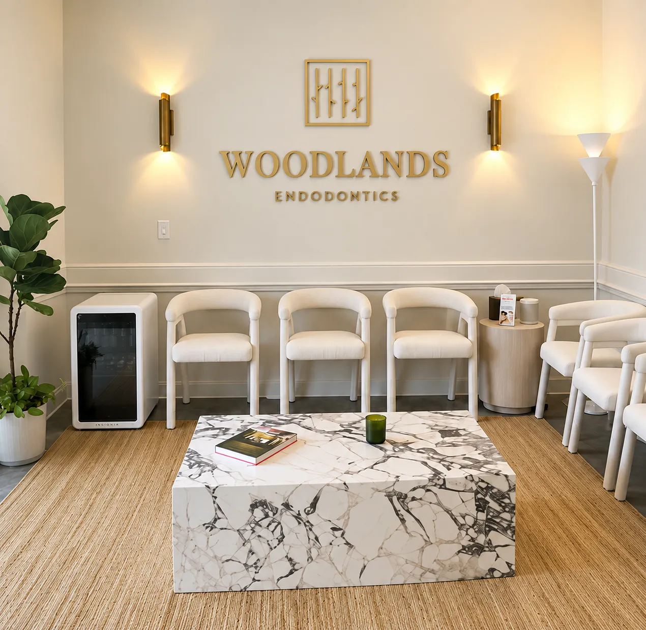 Waiting area at Woodlands Endodontics with the practice logo on the wall